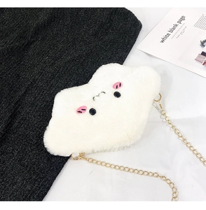 Detail of white plush cloud crossbody bag with embroidered face and golden metal chain