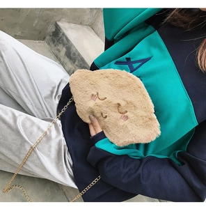 Detail of khaki plush cloud bag with embroidery and gold chain strap on model