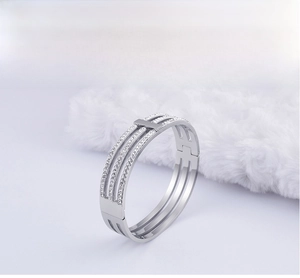 Detail of silver hollow three-layer bangle with micro-pave sparkling crystals on faux fur