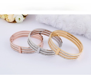 Detailed close-up showing rose gold, silver and gold triple-layered studded bangles
