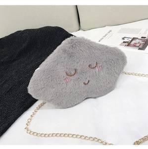 Detail of gray cloud plush bag with embroidered smile and golden chain strap for women
