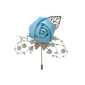 Detail of sky blue satin rose brooch with white pearls and golden hollow leaf