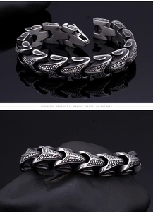 Detail of vintage silver dragon scale steel bracelet showing intricate mechanical textures