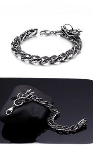 Detail of vintage stainless steel dragon head bracelet with textured scale links