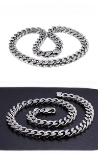 Detailed view of silver thick Cuban chain necklace with vintage embossed clasp design