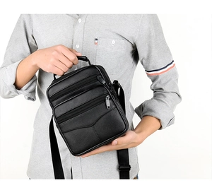 Black genuine leather business shoulder bag for men shown worn with crossbody strap