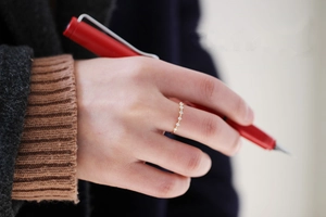 Detailed view of a slender s925 silver 14K gold ring with shimmering cubic zirconia stones