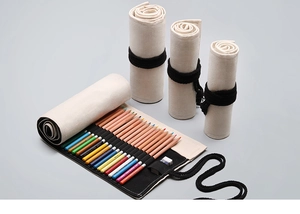 Detailed view of beige canvas pencil roll with black slots and secure tie closure
