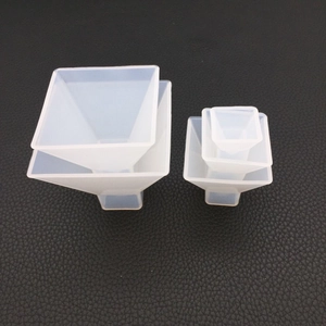 Detailed view of two translucent pyramid-shaped silicone molds for DIY resin art projects