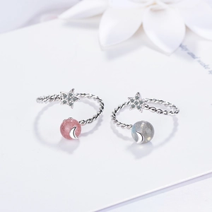 Adjustable silver rings set with moon and star accents and pink strawberry crystal beads