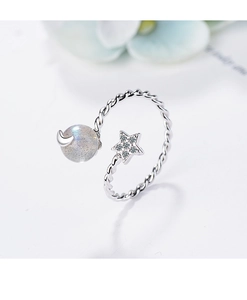 Macro detail of silver adjustable ring with twisted band moon and star moonstone accents