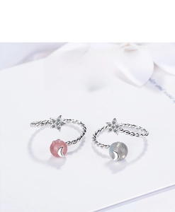 Detail of star and moon rings with pink strawberry crystal and grey moonstone inlay