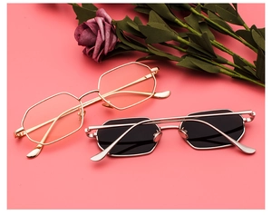 Detail of trendy rectangular sunglasses with metal frames in gold and silver finishes