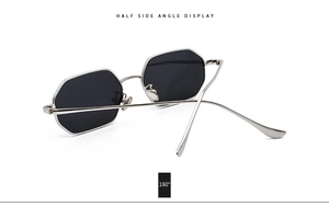 Side view of octagonal silver metal sunglasses with black lenses on white background