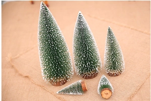 Set of five mini flocked Christmas trees with real wood bases for holiday tabletop decor