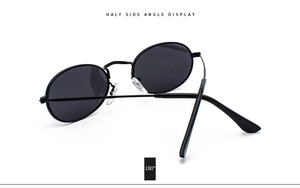 Side view of vintage oval metal sunglasses showing flexible 180-degree hinges