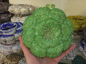 Close-up of emerald green flower evening clutch bag with sparkling crystal rhinestones