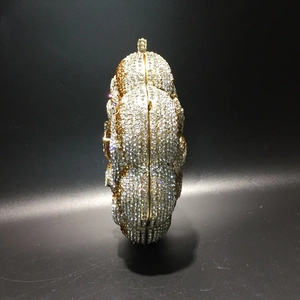 Detailed side profile of luxury crystal clutch bag with champagne rhinestone flower pattern