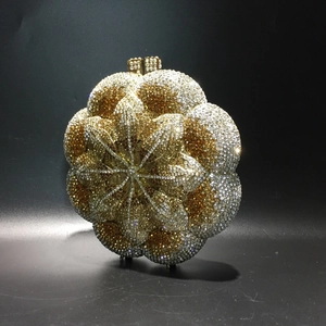 Macro detail of golden rose crystal clutch with intricate rhinestone craftsmanship