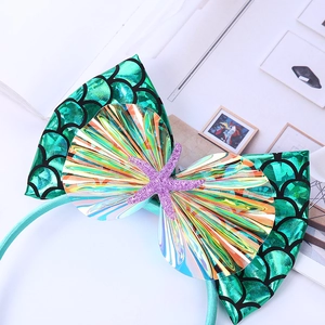 Détail du serre-tête pour enfant avec nœud en écailles, coquillage iridescent et étoile