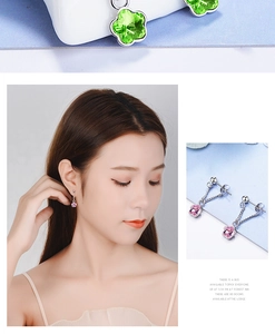 Detail of clover crystal earrings in pink and green colors on model and display
