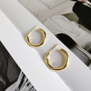 Elegant gold-plated 925 sterling silver irregular C-shaped hoop earrings on display