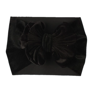 Close-up of black velvet bow headband for girls on a clean white background