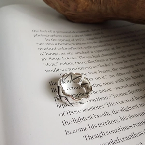 Macro view of textured 925 sterling silver woven ring with vintage matte finish