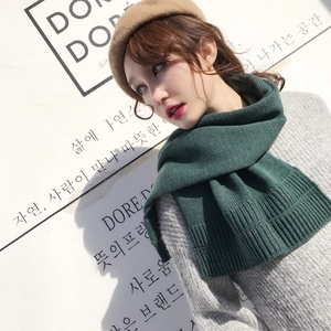 Deep green knitted winter scarf with thick vertical ribbing for women in chic style