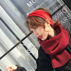 Detail of red cable knit scarf and headband set showing thick ribbed texture for winter