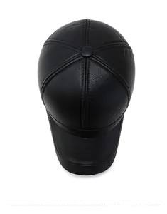 Top down macro view of black PU leather baseball cap showing fine litchi grain texture