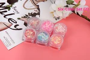Six-color chunky glitter set with stars for eye and nail art makeup on pink background