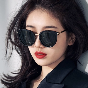 Modische quadratische Sonnenbrille mit goldenen Bügeln, getragen von einem Model im Porträt