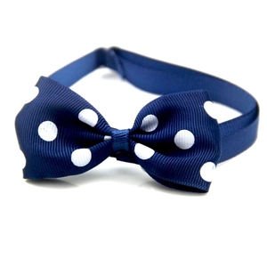 Navy blue polka dot pet bow tie made of ribbed fabric with adjustable elastic strap