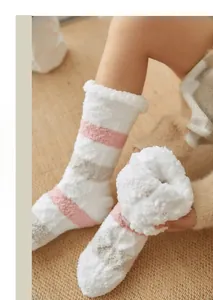 Close-up of thick coral fleece striped thermal socks with plush white folded cuffs