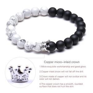 Macro view of zircon-inlaid crown charm on 8mm white turquoise and matte stone bracelet