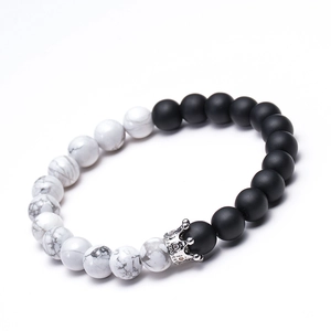 Macro view of 8mm white turquoise and black frosted stone beads with silver crown detail