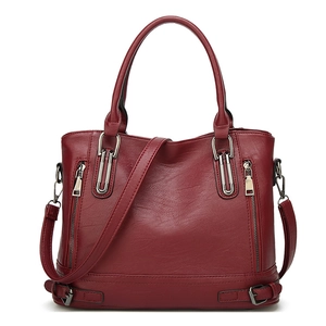 Front view of red PU leather tote bag with dual handles and side zipper pocket detail