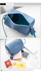 Blue litchi grain cylindrical bag interior showing spacious storage for makeup and phone