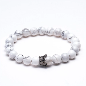 Macro view of white turquoise beads and micro-paved zircon crown on the bracelet