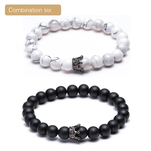 Detailed view of white turquoise and black lava stone bracelets with micro-pave crown charms