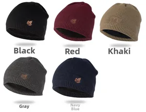 Close-up of assorted winter knit beanies in black, red, khaki, gray and navy blue with maple patch