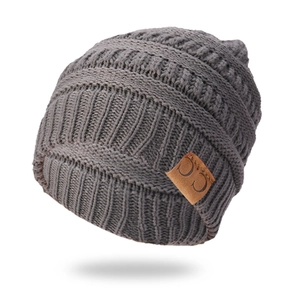 Close-up of grey ribbed knit beanie showing high-quality texture and C.C leather patch
