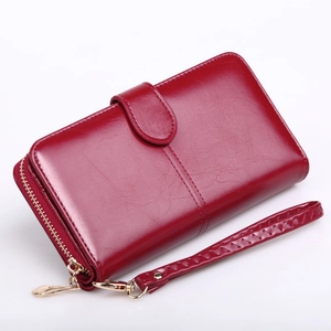 Long dark red oil wax leather wallet with zipper, wristlet strap, and buckle for women