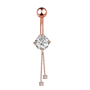 Close-up of rose gold navel ring with sparkling round zircon stones and dangling chains