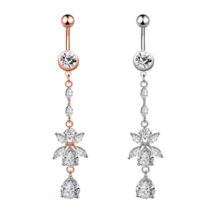 Detailed close-up of rose gold and silver navel rings featuring drop zirconia crystals