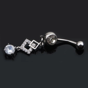 Macro shot of stainless steel navel ring with sparkling zircon and square pendants