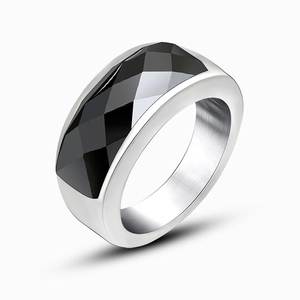 Polished silver stainless steel ring featuring a large faceted geometric black stone