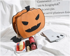 Detail of pumpkin crossbody bag showing capacity for a smartphone and cosmetics