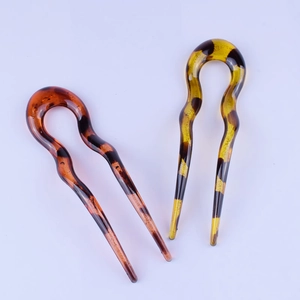 Pair of U-shaped tortoise shell hair pins in amber and brown resin finish